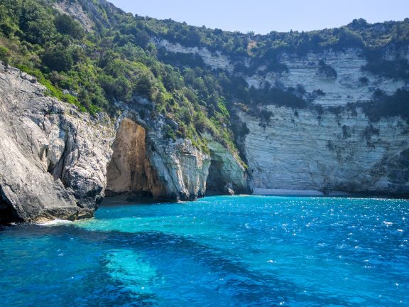 Beautiful view of the blue cave of Paxos island. The purest water with an amazing turquoise hue. Corfu, Greece