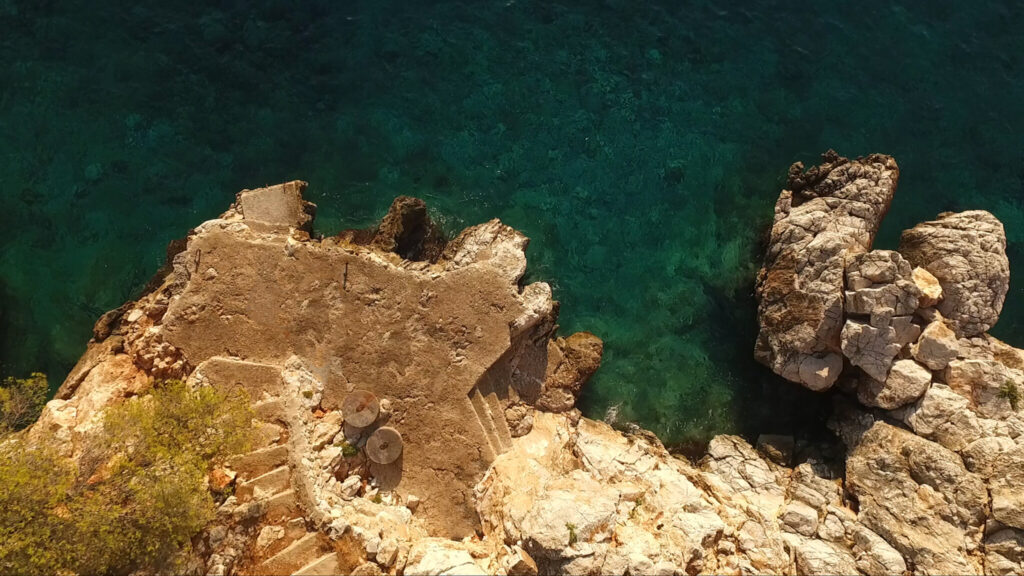 The coves and pine-covered shore of Agistri from the air, Saronic Gulf