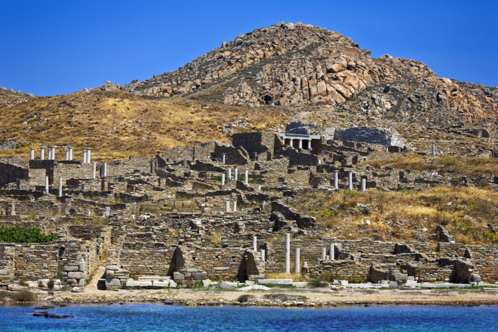 Greece. Cyclades Islands - Delos. Remains of ancient Sanctuary of Apollo, above Kynthos hill. “After arriving in Delo while he was returning from Crete … Theseus danced with the young Athenians a dance still performed by the inhabitants of the island, consisting of twisting and twisted movements that reproduce the shapes of the labyrinth. Dicearchos states that this dance is called “Crane” (Plutarch, Theseus, 21).