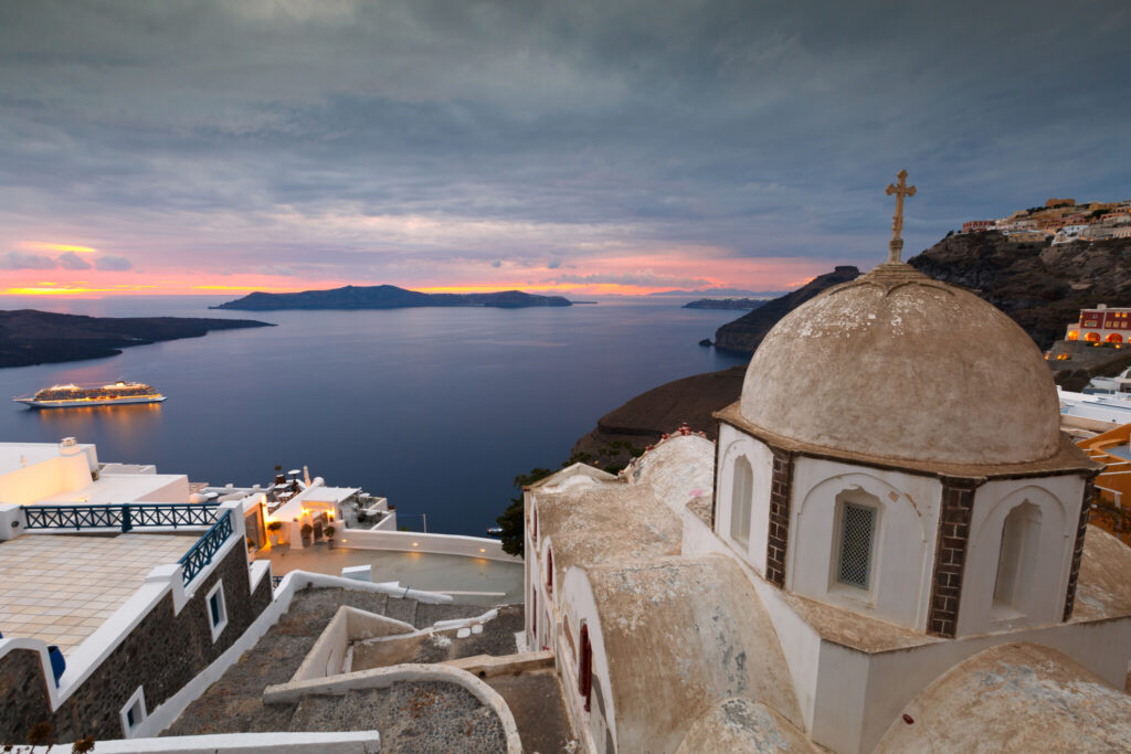 View of Nea Kameni (island) from the Town of Fira. We recommend visitin after the crew ships have left and continuing with hot springs.