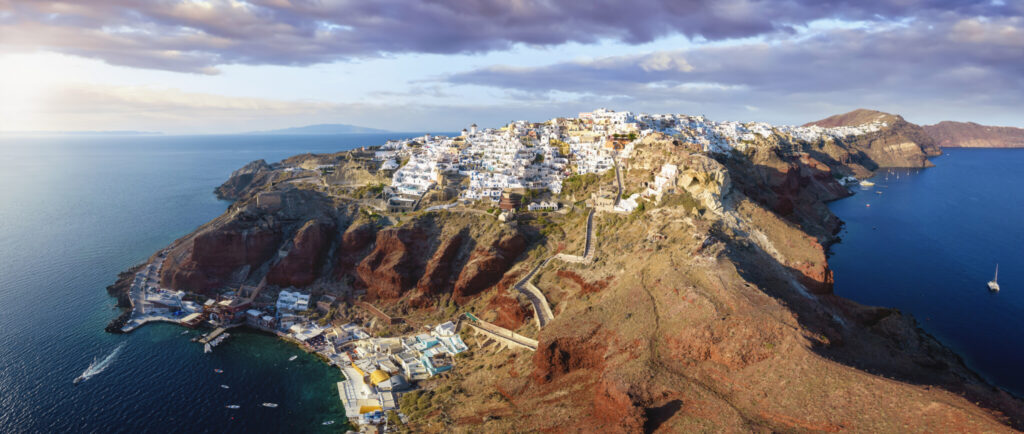Oia on the caldera rim of Santorini from the air in evening light