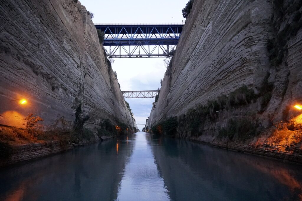 The Corinth Canal at dusk, sheer rock walls and the bridges above