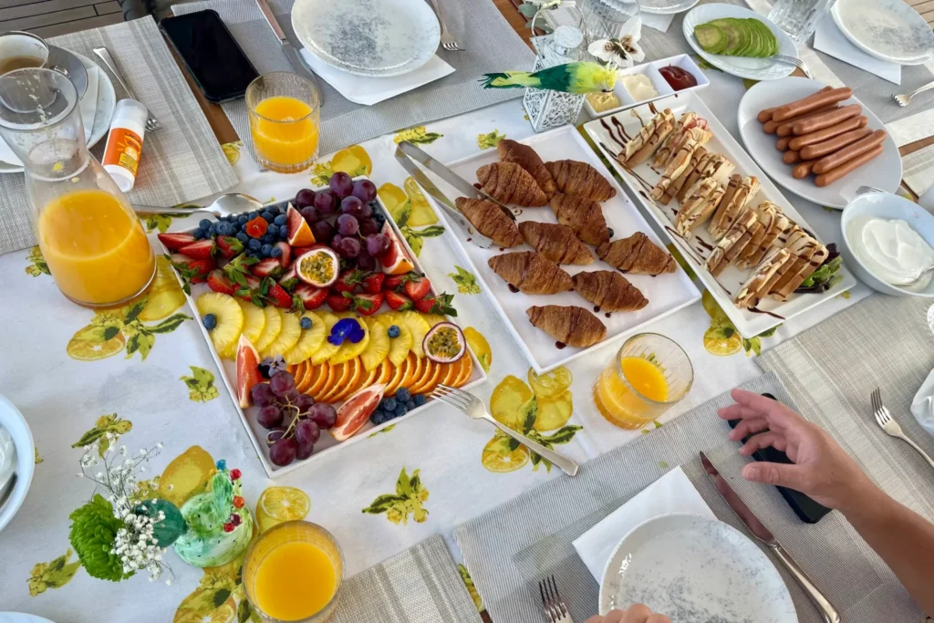 Breakfast spread on the flybridge table of motor yacht ANKA: fruit platter, croissants, juice