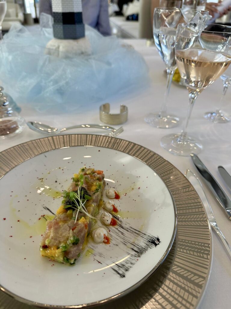 Tuna tartare with caviar plated on motor yacht HAKUNA MATATA at a broker tasting, rose wine behind