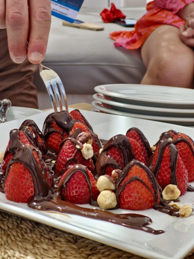 M/Y MILOS AT SEA serves Strawberries & Chocolate Fresh strawberries drizzled with rich dark chocolate and topped with toasted hazelnuts—simple, bold, and totally irresistible.