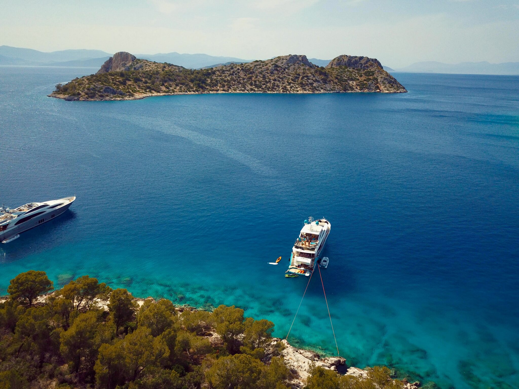 Motor yacht ANKA anchored stern tied to the rocks in the Saronic Islands in Greece