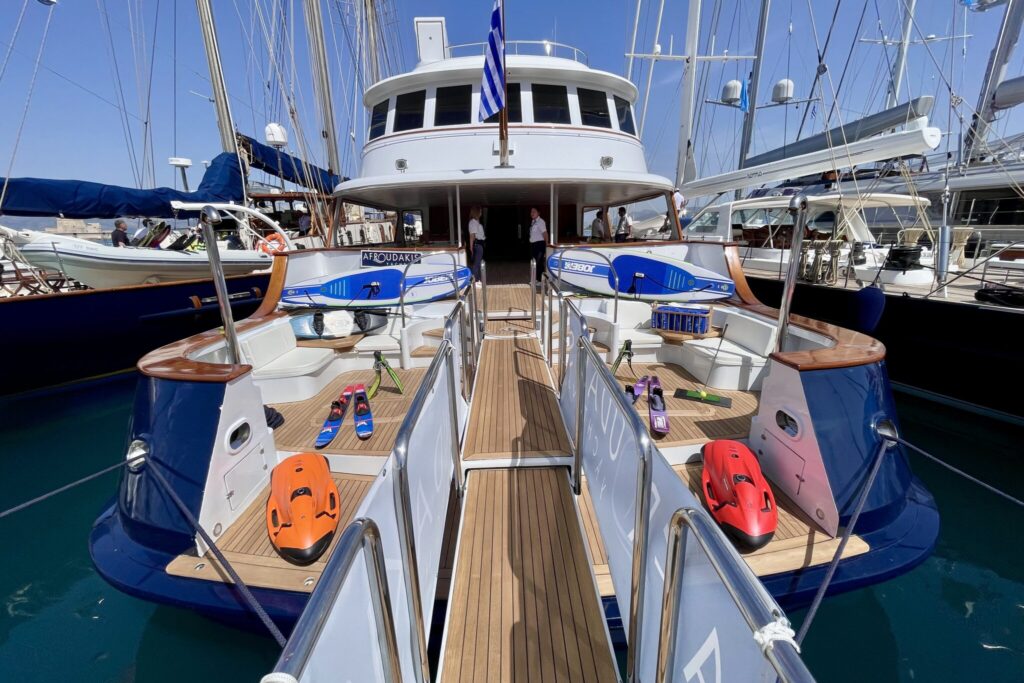 Motor yacht WIND OF FORTUNE at the MEDYS yacht show, Greek flag flying over the sundeck