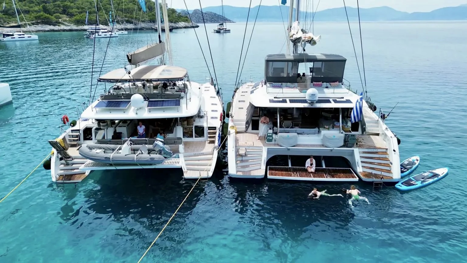 Two catamarans rafted together for a tandem charter
