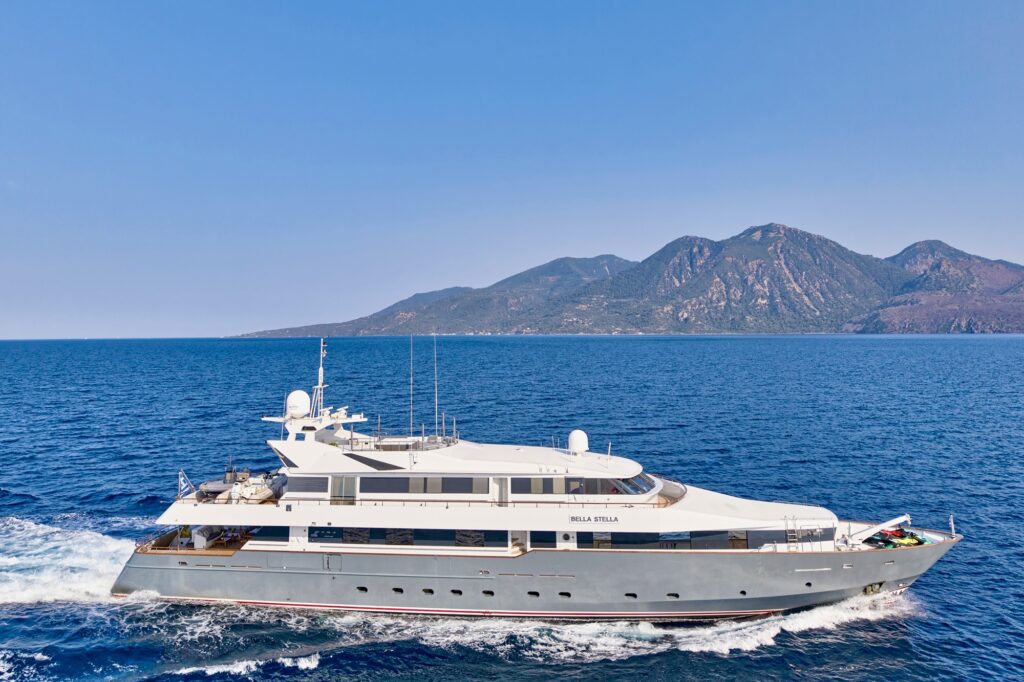 Motor yacht BELLA STELLA underway off the Greek coast, Greek flag flying
