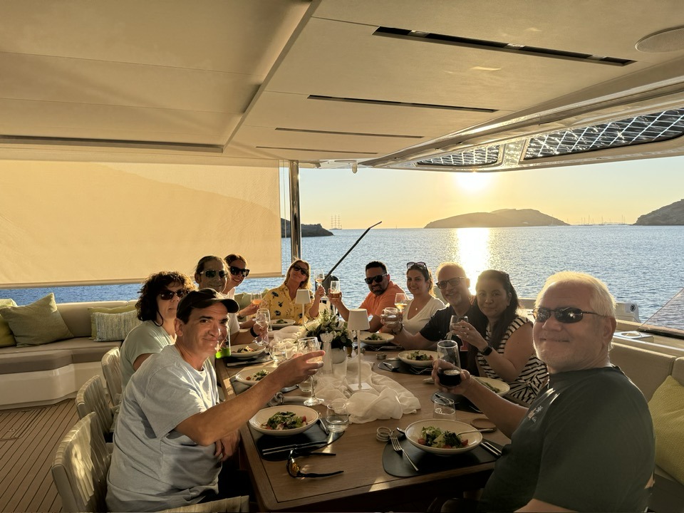 Guests enjoying dinner on a catamaran in Greece