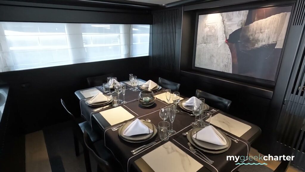 The black and white dining room on motor yacht PROJECT STEEL, laid for dinner