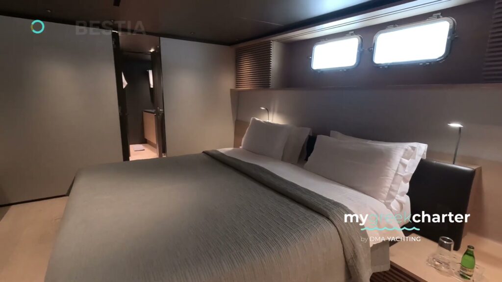 A guest cabin on motor yacht BESTIA with a double bed and hull windows