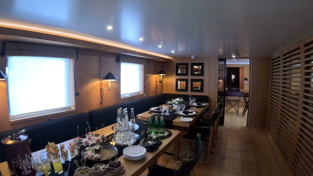 The wood panelled dining saloon on motor yacht SOUNION II, a 1969 Benetti