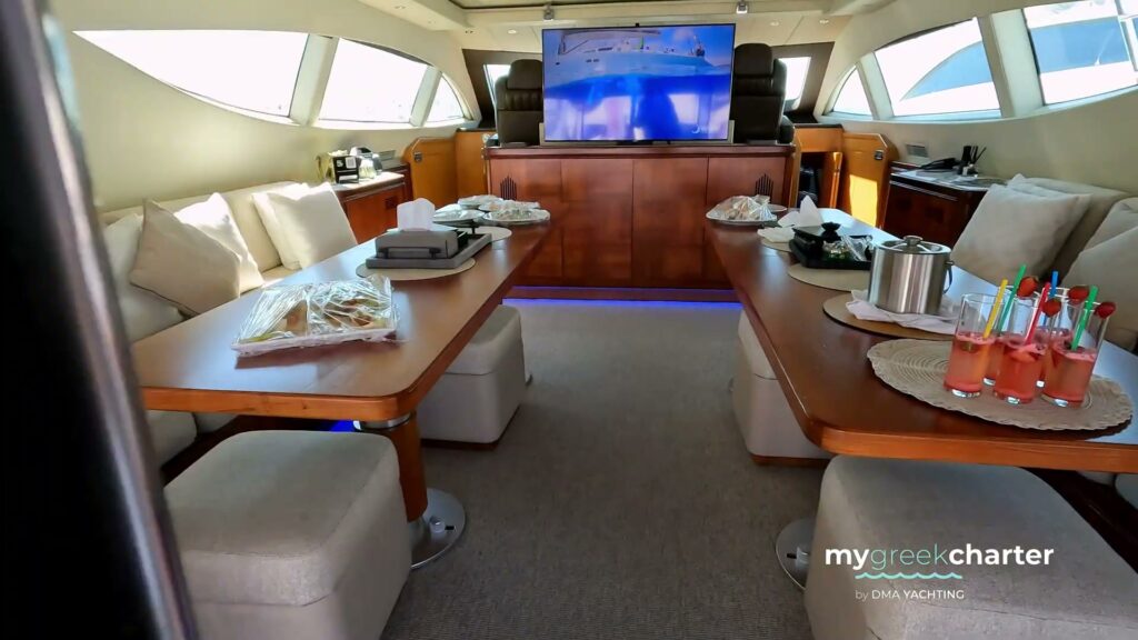 The saloon of motor yacht WET PANTHER with its dining tables and sofas