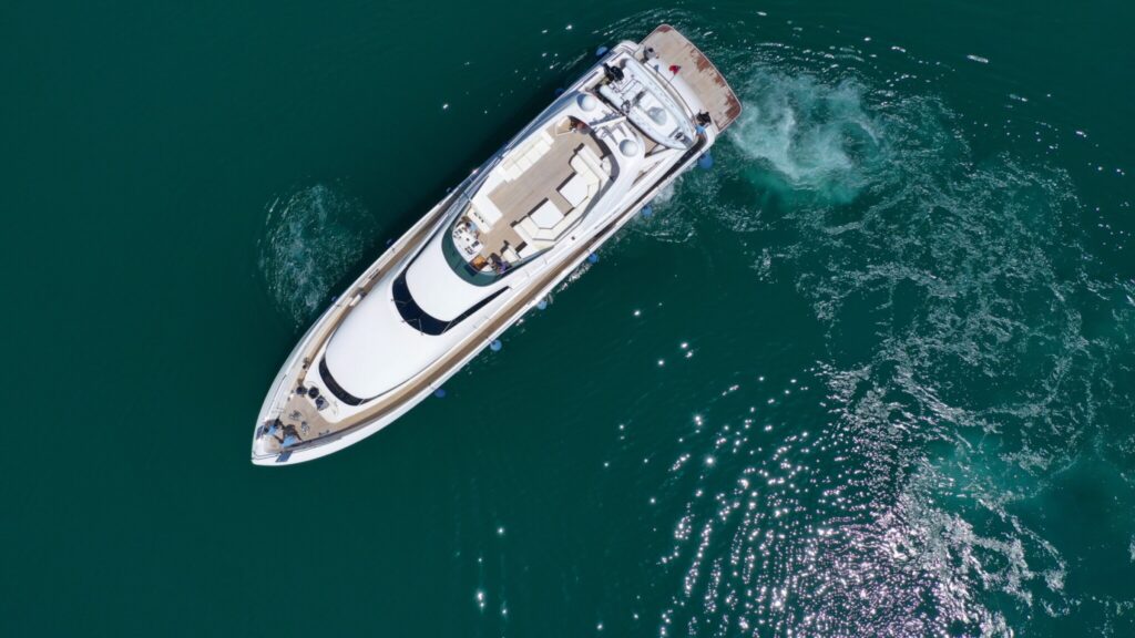 Aerial view of a single luxury motor yacht underway off Mykonos on a Greece yacht charter