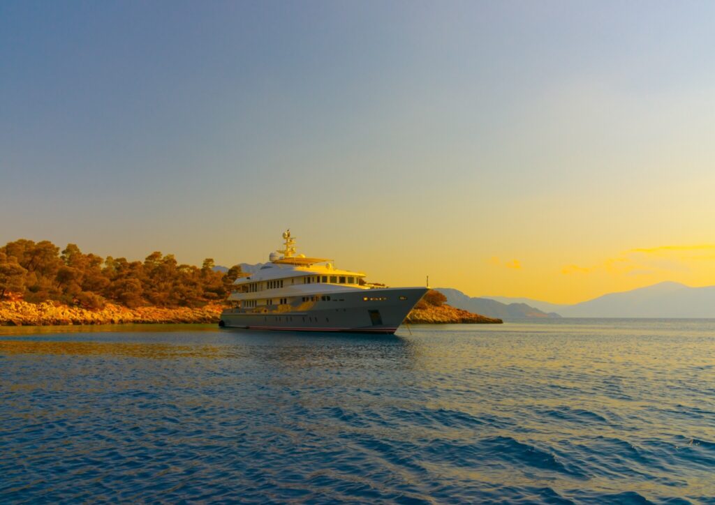 Superyacht anchored off a pine-covered islet in the Saronic Gulf, Greece
