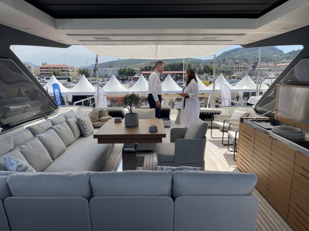 The aft deck lounge of motor yacht AKASTI at a yacht show, May 2025.