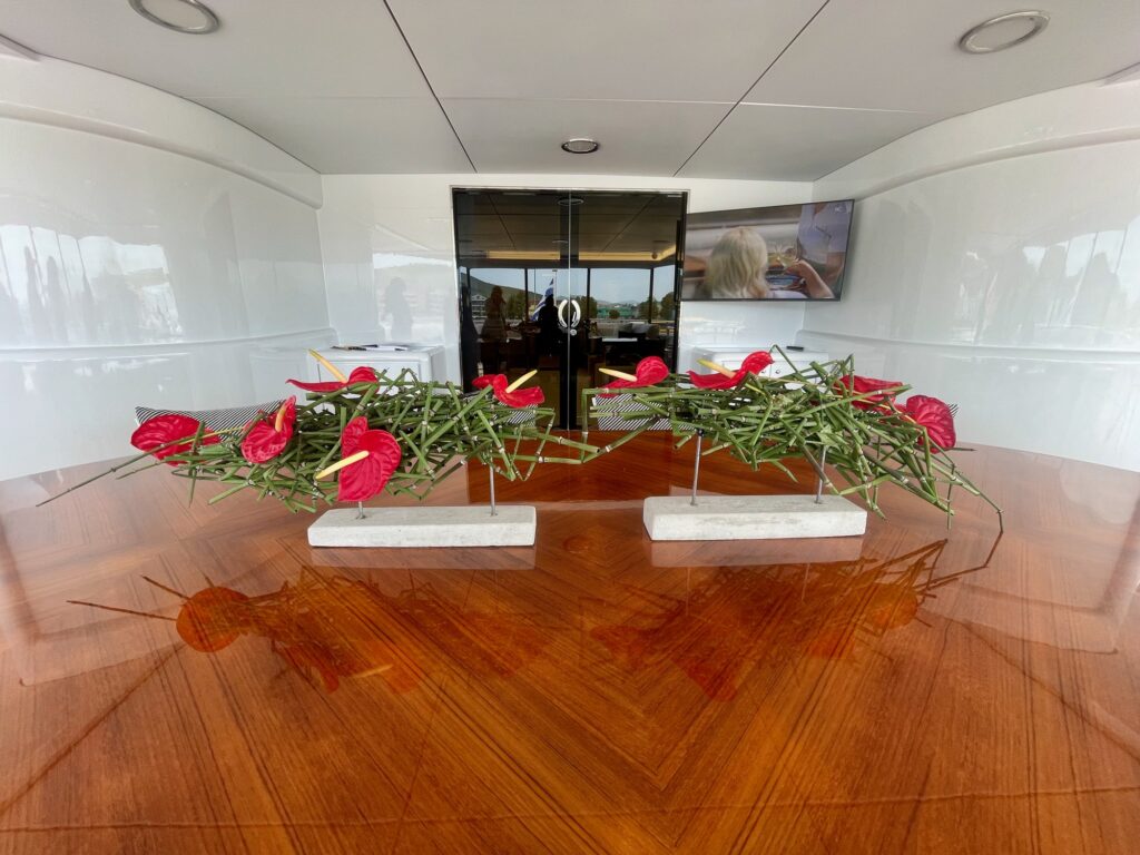 Red anthurium arrangement on ARTEMISEA's flybridge table