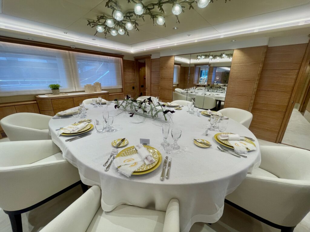 ARTEMISEA's dining table laid with gold-rimmed plates and glassware