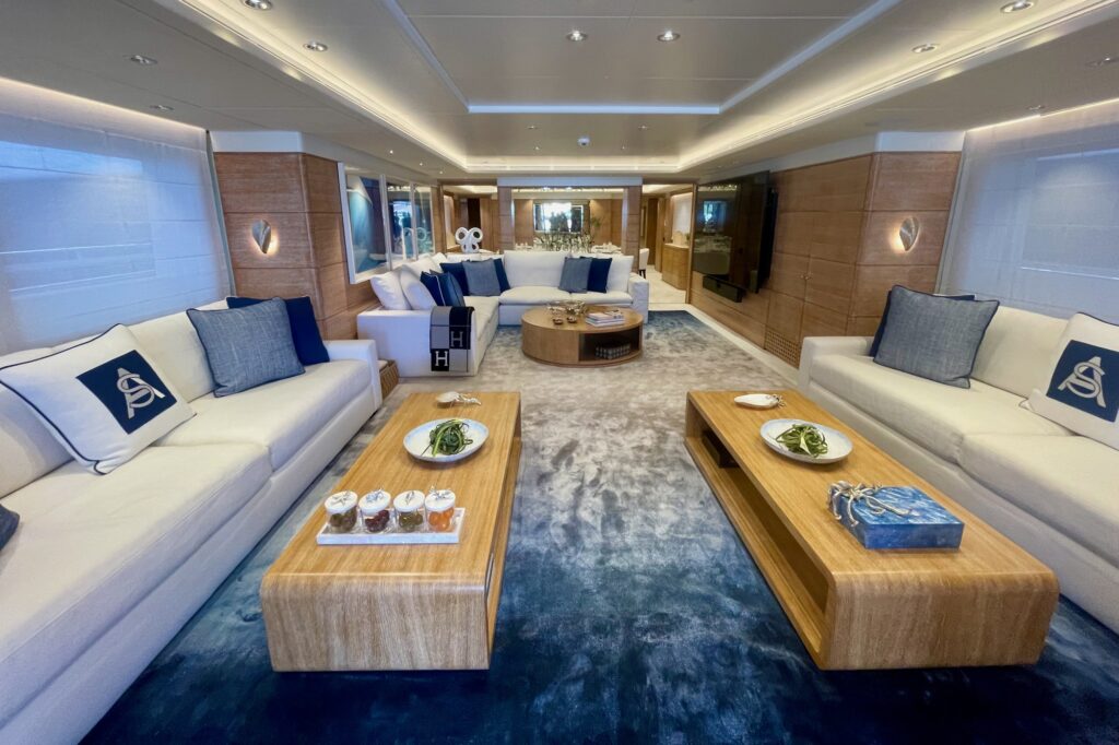 ARTEMISEA's main saloon with two cream sofas and twin oak coffee tables