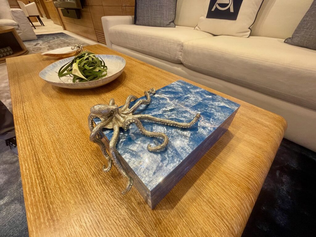 A bronze octopus sculpture on a blue resin block on ARTEMISEA's saloon coffee table