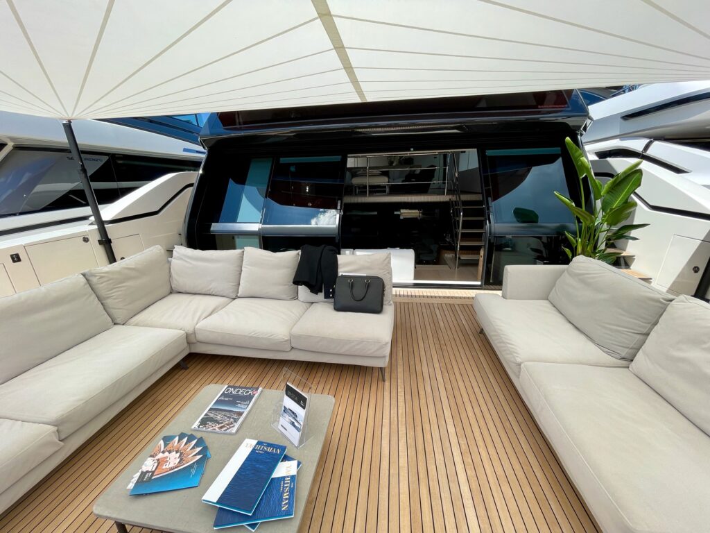 BESTIA's aft-deck lounge with white sofas under the awning