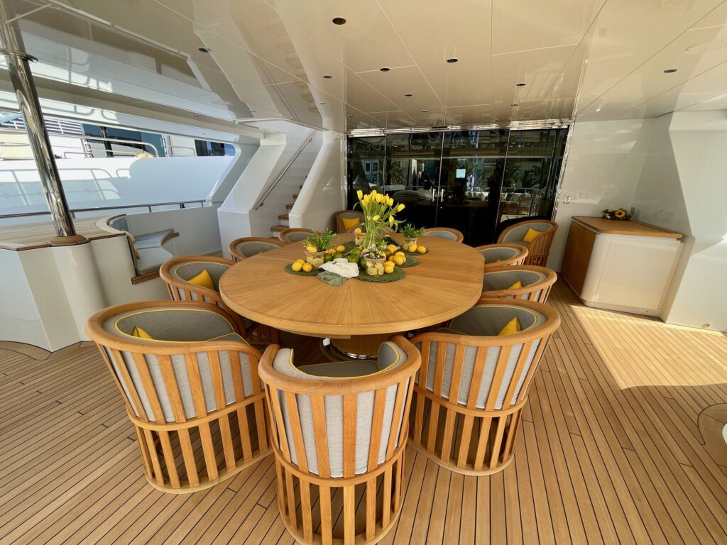 BOJI, the aft-deck table with the yellow-trimmed chairs