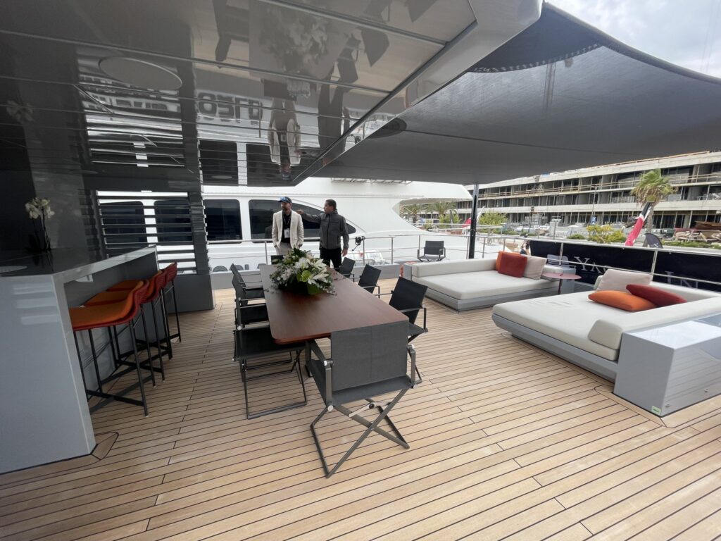 The aft deck with dining table and sun pads on motor yacht CARMEN, October 2025.