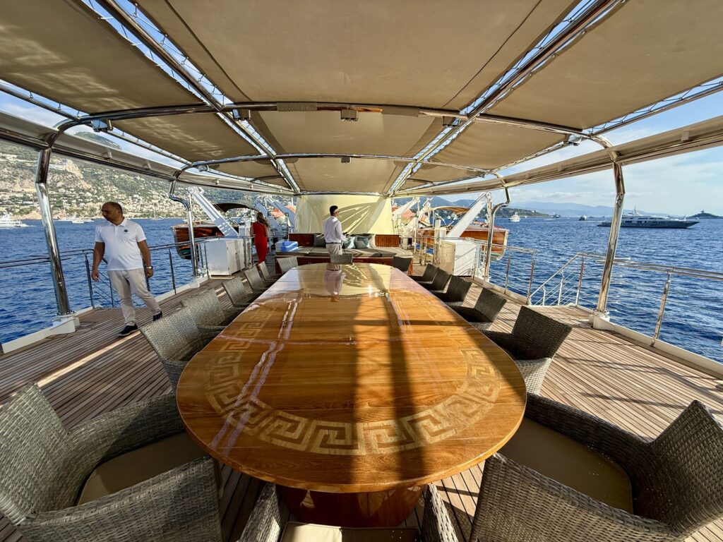CHRISTINA O, the aft-deck dining table under the awning