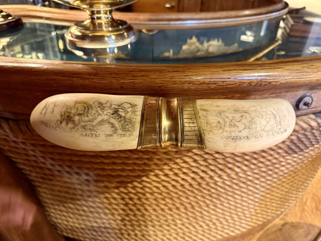 CHRISTINA O, the whale-tooth handles and etched scenes on Ari's Bar