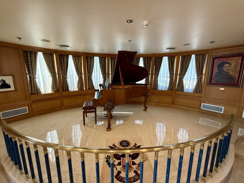 CHRISTINA O, the piano on its railed dais in the Callas Lounge