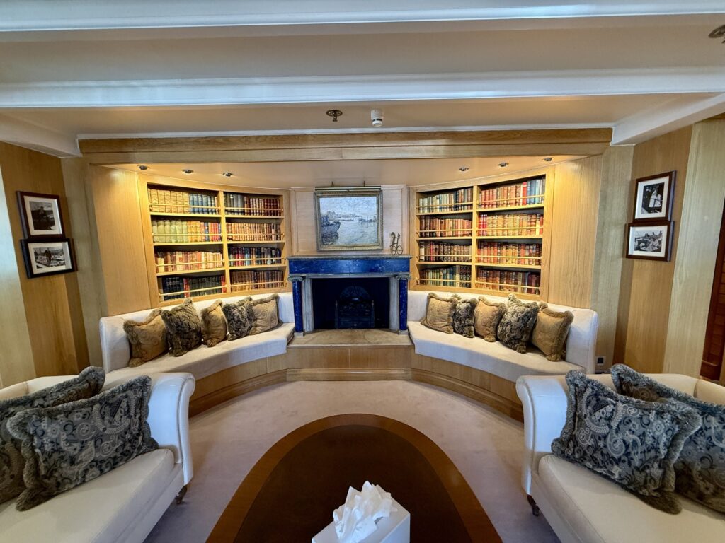 CHRISTINA O, the curved sofa and bookshelves in the library lounge