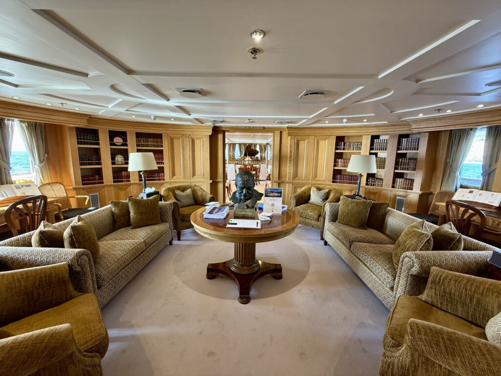 CHRISTINA O, the library with its round table and velvet sofas