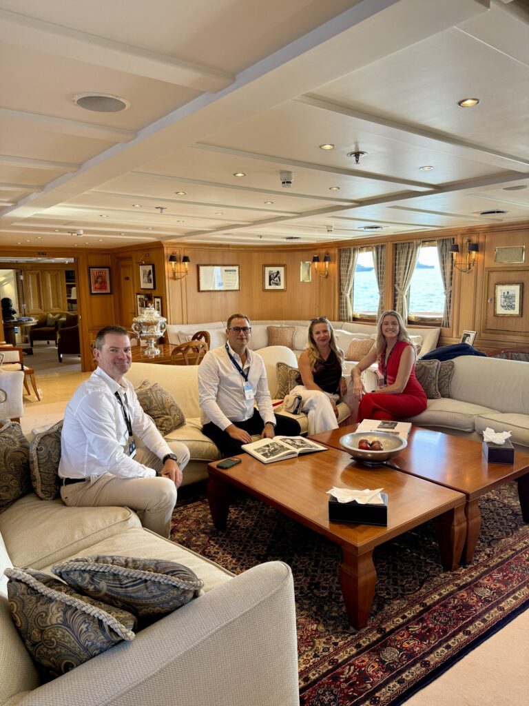 CHRISTINA O, the DMA Yachting team seated in the main lounge