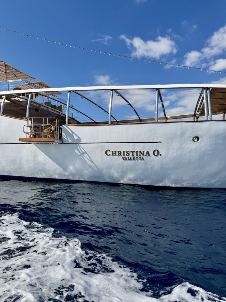 CHRISTINA O, her stern seen from the tender, at anchor off Monaco