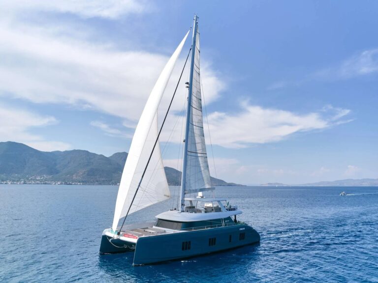 GENNY, a dark grey Sunreef 80 charter catamaran, under sail in Greece