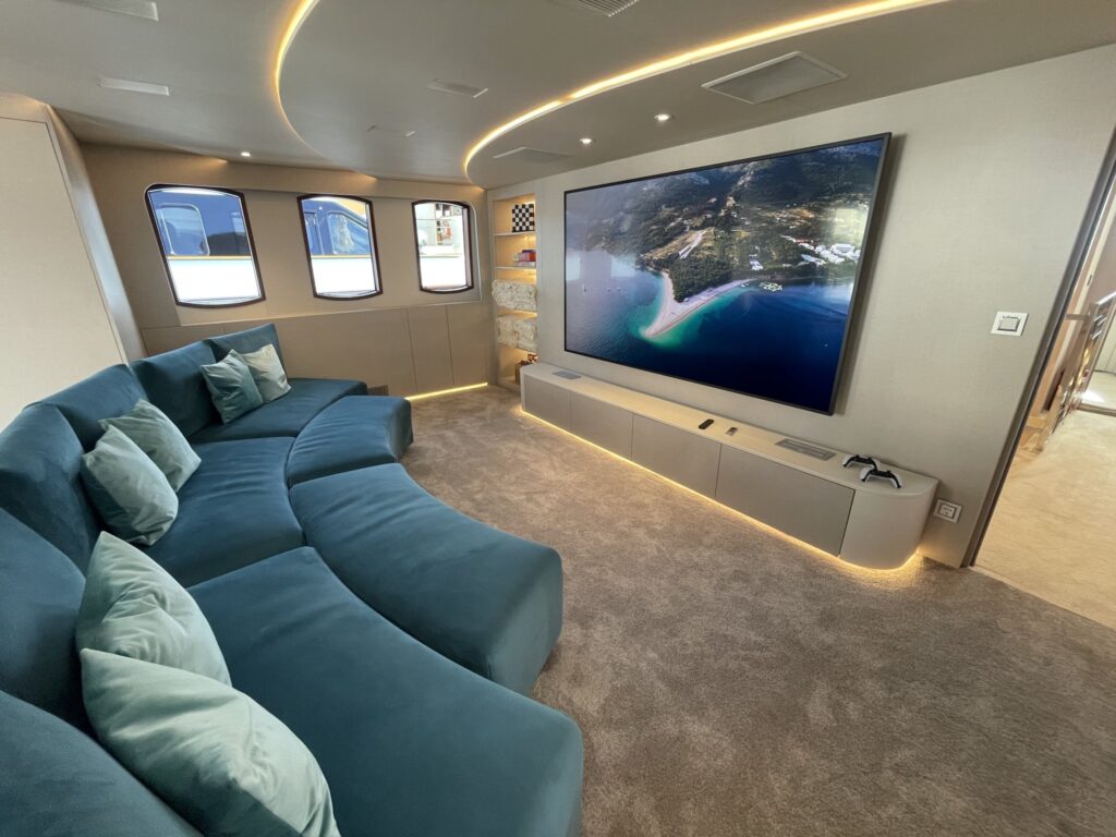 The cinema lounge with a curved sofa on motor yacht MAIA, September 2025.