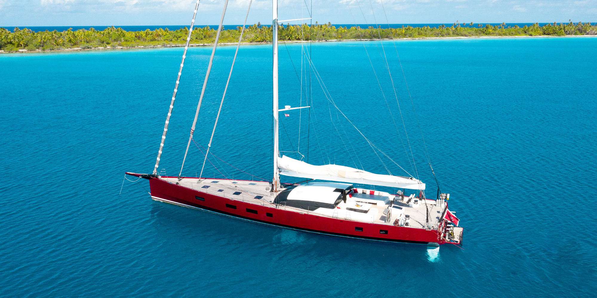 The red-hulled sailing yacht NOMAD IV at anchor