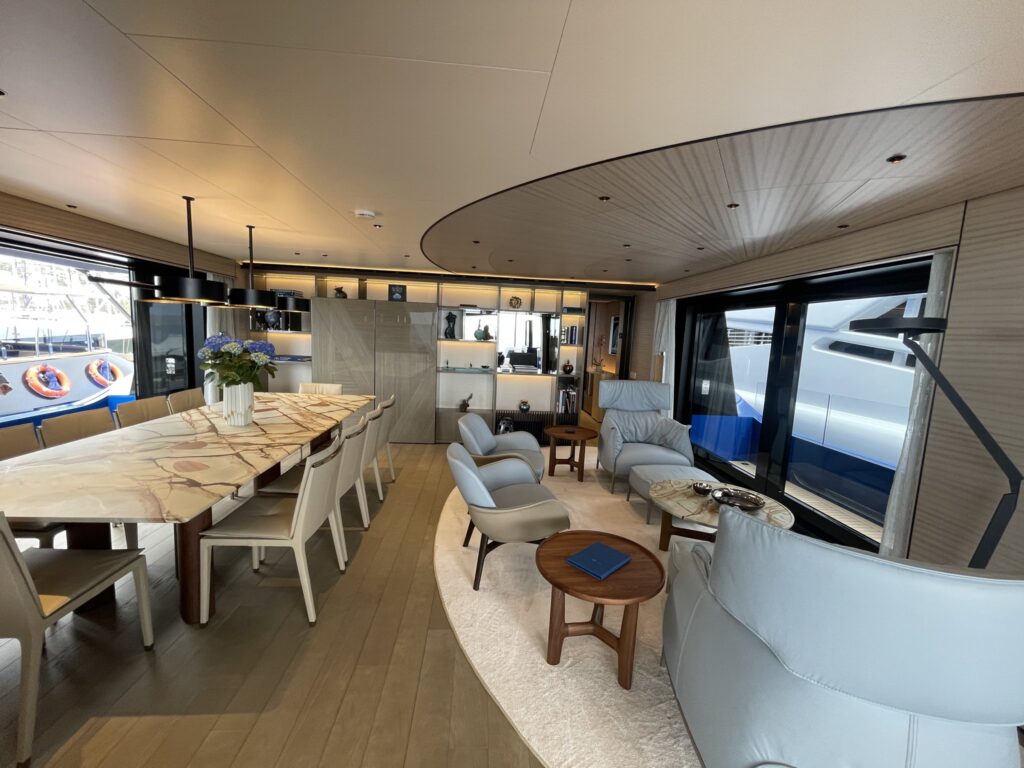 The dining table and saloon of motor yacht SUI GENERIS, April 2026.