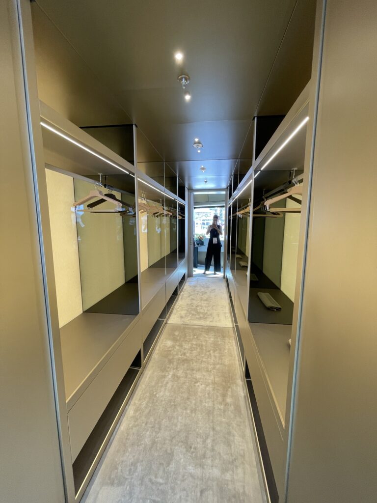 Mirrored walk-in wardrobe corridor leading into the master suite on THIS IS IT