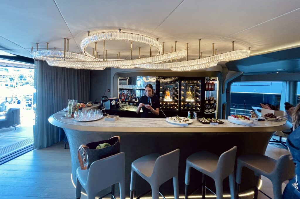 Curved bar in the main saloon of THIS IS IT with a circular crystal chandelier above