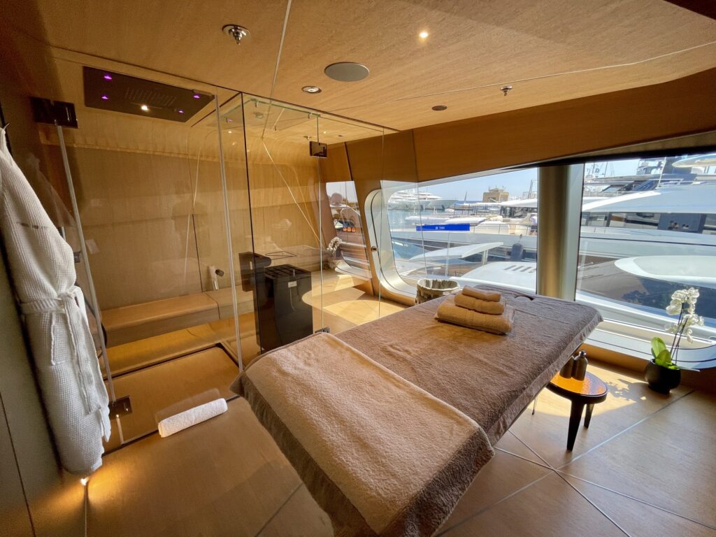 Massage bed and glass-walled sauna in the spa room on THIS IS IT
