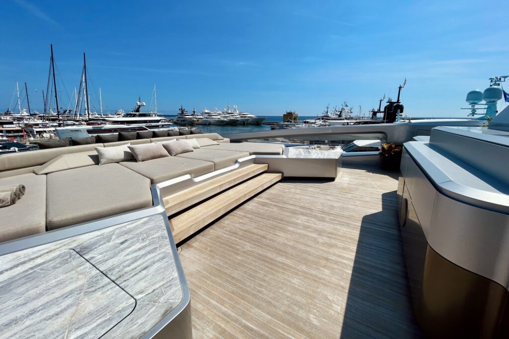 Teak sundeck with built-in sunpads on THIS IS IT, marina in the background