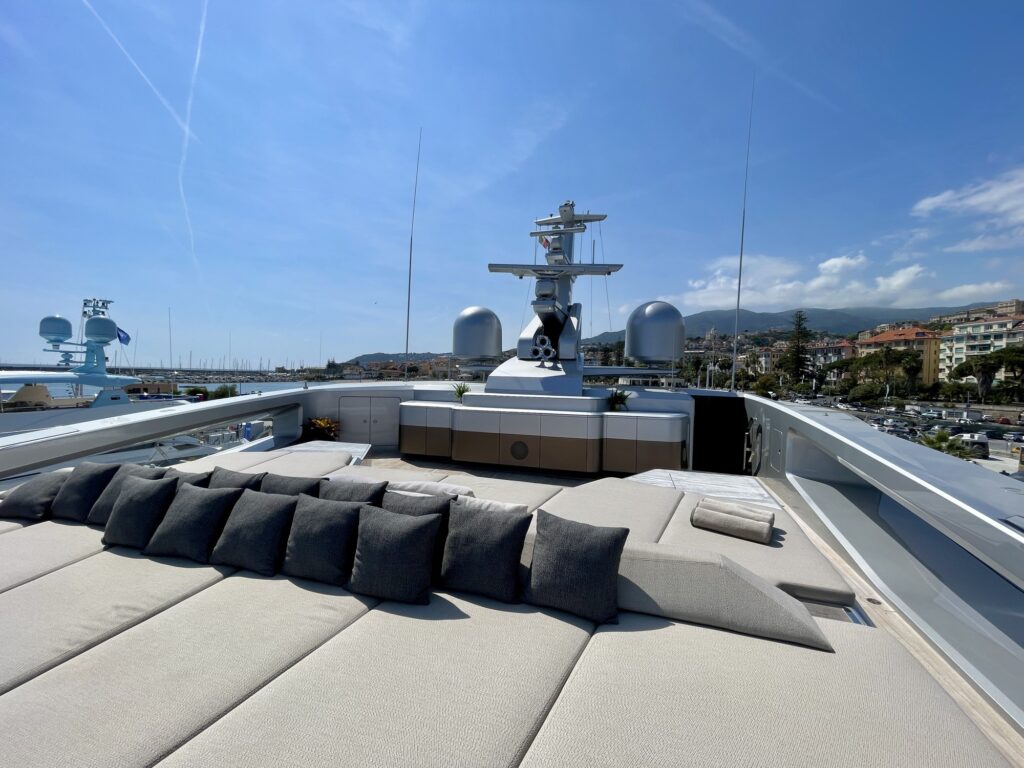 Cushioned lounge on the forward sundeck of THIS IS IT with the radar mast behind