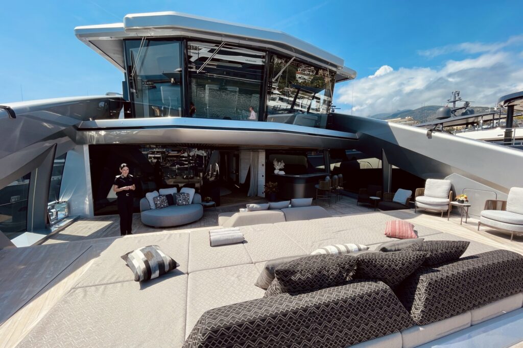Sunpads and loungers on the sundeck of THIS IS IT with the glass wheelhouse behind