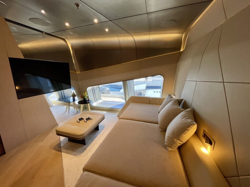 Cream daybed and wall screen in a small TV lounge on THIS IS IT