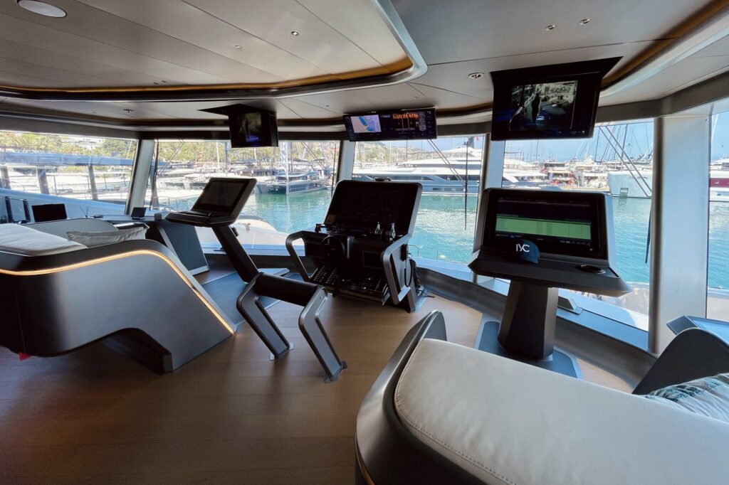 Futuristic helm station with floating screens in the glass wheelhouse of THIS IS IT