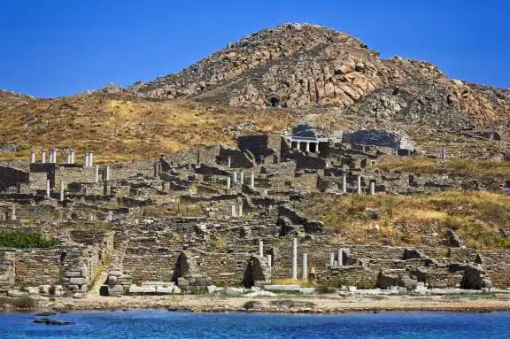 Greece. Cyclades Islands - Delos. Remains of ancient Sanctuary of Apollo, above Kynthos hill. “After arriving in Delo while he was returning from Crete … Theseus danced with the young Athenians a dance still performed by the inhabitants of the island, consisting of twisting and twisted movements that reproduce the shapes of the labyrinth. Dicearchos states that this dance is called “Crane” (Plutarch, Theseus, 21).