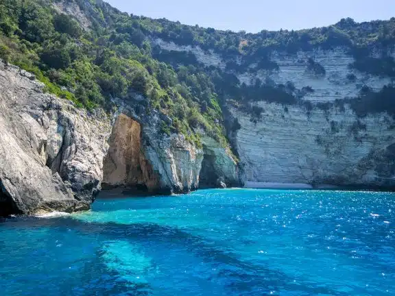 Beautiful view of the blue cave of Paxos island. The purest water with an amazing turquoise hue. Corfu, Greece