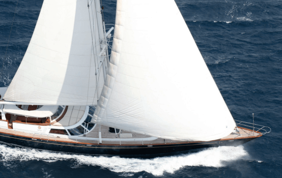 Luxury Sailing Yacht with sails up, cutting through the water.